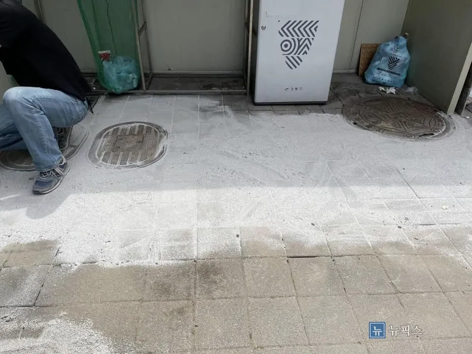 규사를 빗자루로 쓸어 줄눈 사이로 밀어 넣는 마무리 작업